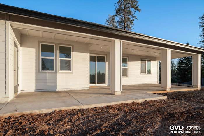Custom-built home exterior in Paradise, CA featuring James Hardie Board and Batten siding, expansive porch, and large windows