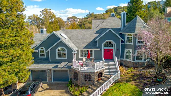 Home exterior featuring Night Gray James Hardie siding, Arctic White trim, and a red front door in Petaluma, CA