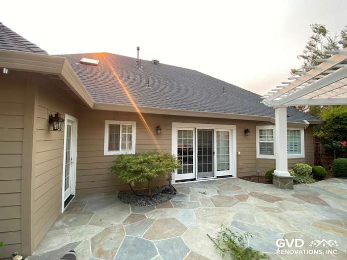 Khaki Brown James Hardie siding on a unique home exterior with a stone patio in Petaluma