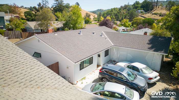 Home exterior featuring James Hardie Arctic White siding, new windows, and a sloped roof in Pinole, CA
