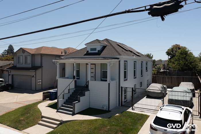 San Leandro home featuring Arctic White James Hardie Color Plus Lap Siding and trim with a modern roof design