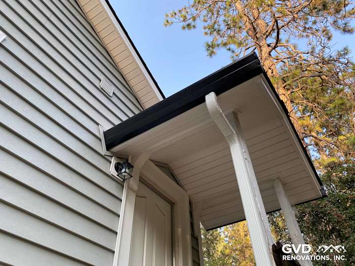Close-up of home exterior featuring Prodigy Vinyl Siding in light gray with black trim in Grass Valley