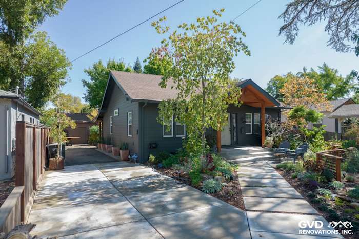 Modern Sacramento home featuring James Hardie Iron Gray siding, lush landscaping, and inviting entryway