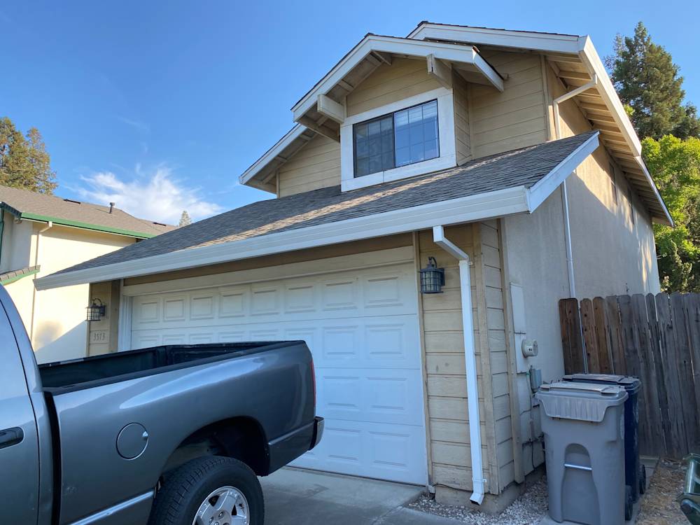 Two-story house in Sacramento with beige siding and a single-car garage