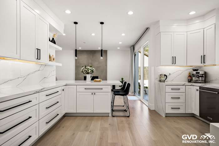 Elegant kitchen remodel featuring quartz countertops, custom white cabinets, and modern bar seating in Antelope, CA