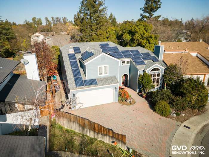 Home exterior featuring Boothbay Blue James Hardie siding, solar panels, and landscaped driveway in Davis, CA