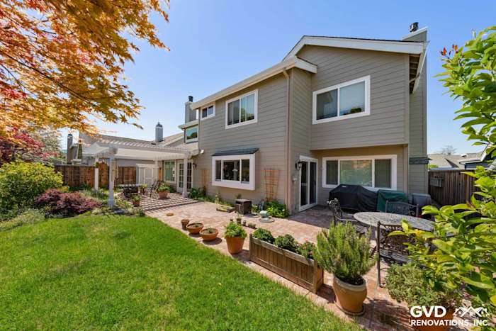 Monterey Taupe James Hardie Lap Siding and Arctic White trim on a Foster City home exterior with a landscaped yard