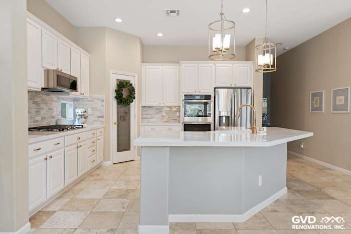 Bright Sacramento kitchen with white cabinets, quartz island, stainless steel appliances, and modern fixtures