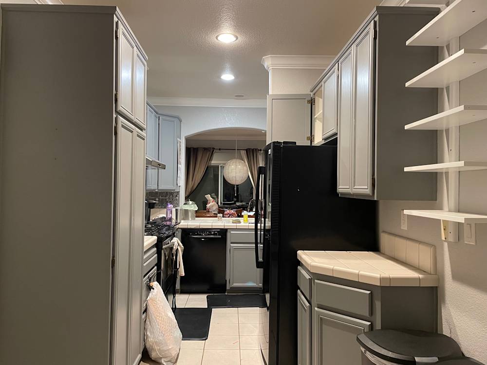 Compact kitchen in Folsom with gray cabinets, black appliances, and tile flooring
