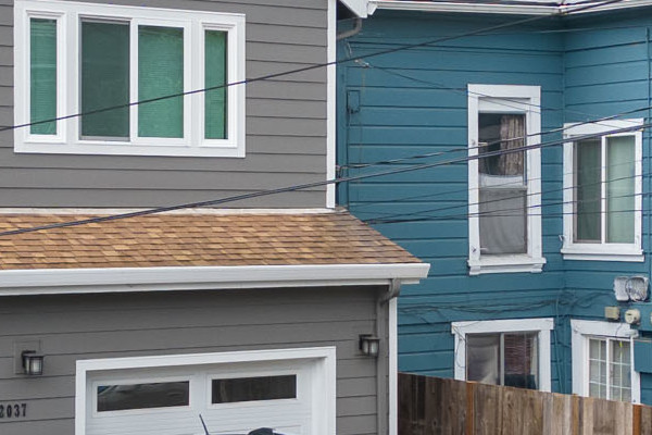 Updated Oakland home featuring Aged Pewter James Hardie siding, Arctic White trim, and a modern garage