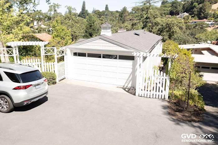 Driveway view of home featuring new Pearl Gray James Hardie shingle siding and white trim in Orinda, CA