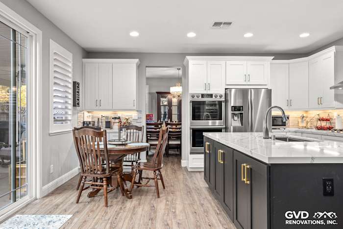 Modern kitchen remodel featuring Cambria countertops, custom cabinets, and a dining area in Roseville, CA