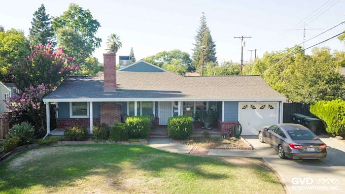 Home exterior featuring Boothbay Blue James Hardie siding, Arctic White trim, and a charming front yard in Sacramento