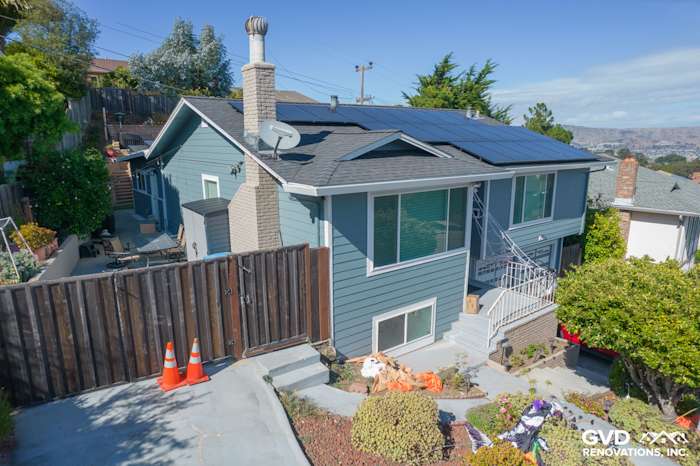 Two-story home in San Bruno with Boothbay Blue James Hardie siding and Arctic White trim, featuring solar panels and lush