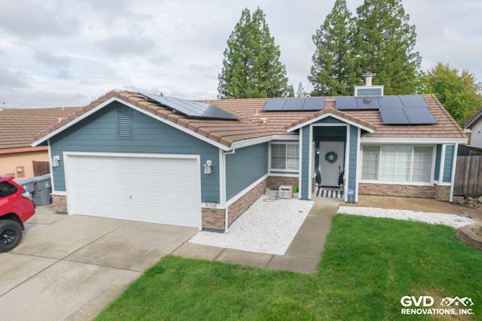 Home exterior in Rocklin with Evening Blue James Hardie siding, Arctic White trim, and Eldorado Stone accents