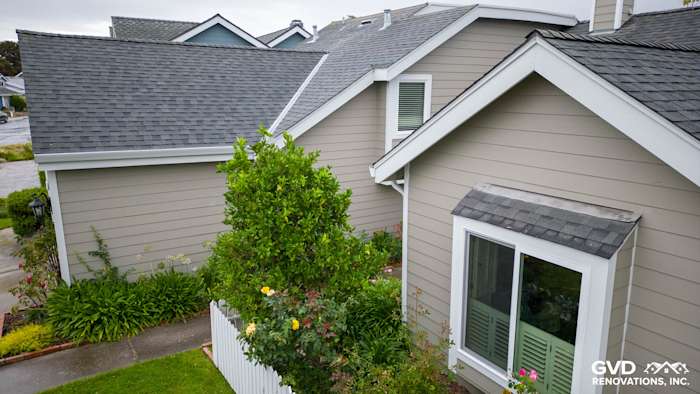 James Hardie siding in Monterey Taupe with Milgard windows, featuring a well-landscaped yard in Foster City