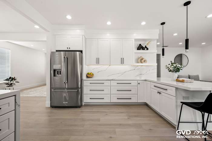 Modern kitchen featuring white cabinets, quartz countertops, and stainless steel appliances in Antelope, CA