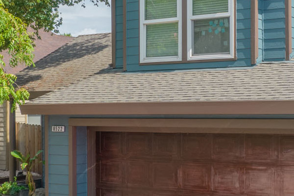 Two-story home in Antelope with painted James Hardie siding and Anlin windows, featuring a red car in the driveway