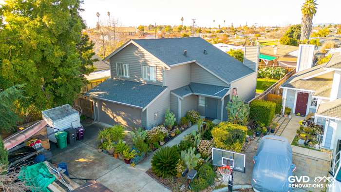Updated home exterior featuring Alside Prodigy Vinyl siding in Ageless Slate color, surrounded by landscaping in Hayward, CA