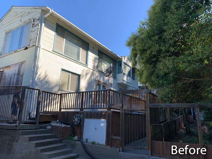 Home exterior before renovation showcasing old siding, worn wooden deck, and outdated windows in Oakland, CA