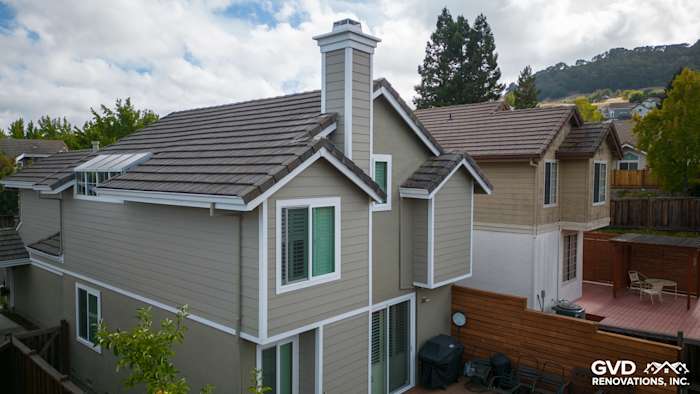 Home exterior showcasing James Hardie Monterey Taupe lap siding with Arctic White trim and chimney detail in Danville