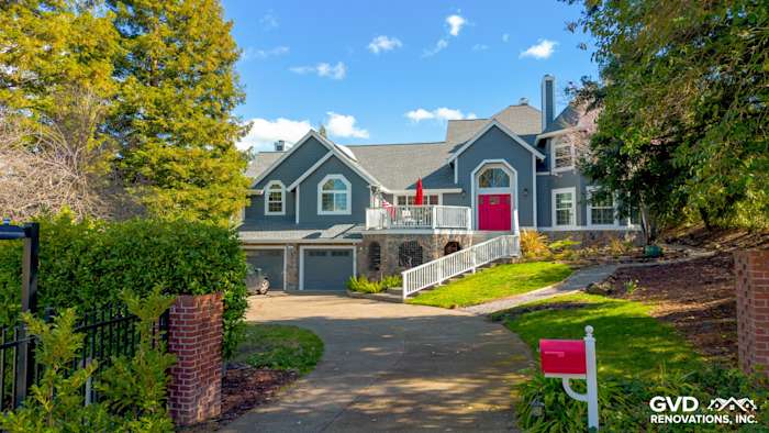 Petaluma home exterior featuring Night Gray James Hardie siding and Arctic White trim with vibrant red front door