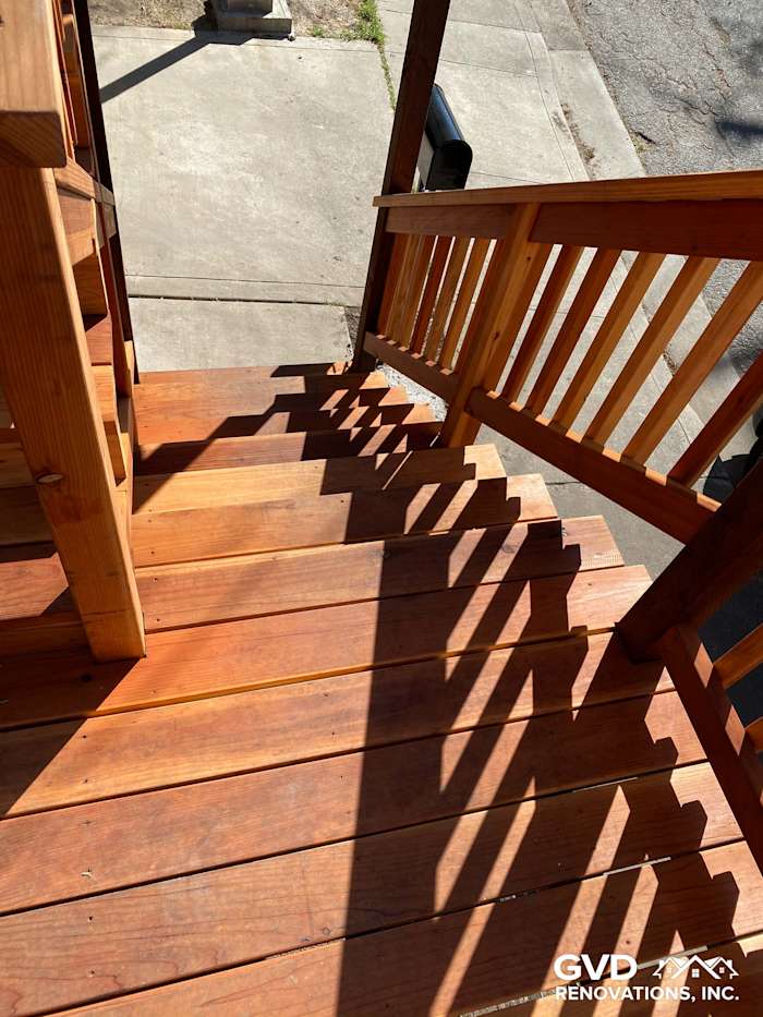 New wooden deck with side steps and shadow patterns, showcasing quality construction in Rio Vista
