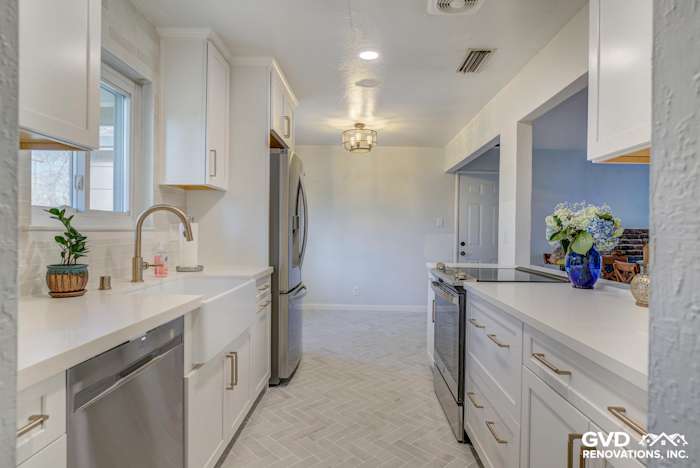 Light-filled kitchen renovation featuring white cabinetry, quartz countertops, and stainless steel appliances in Fair Oaks