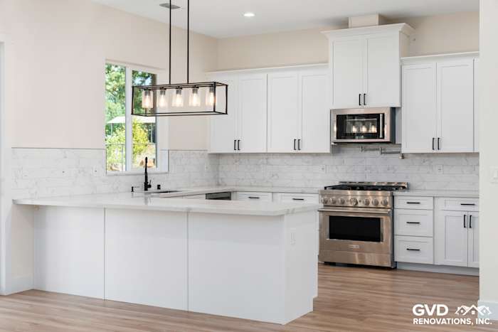 Bright kitchen featuring white shaker cabinets, marble backsplash, and stainless steel appliances in Paradise, CA