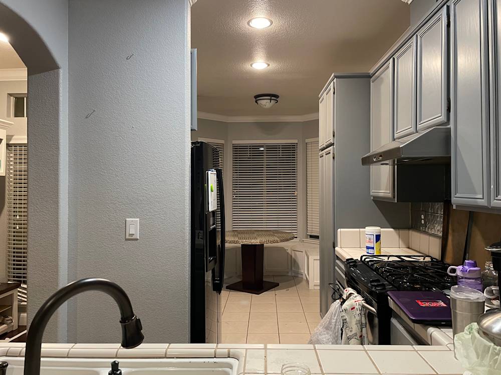 Spacious Folsom kitchen featuring gray cabinetry, tile flooring, and ample natural light from large windows