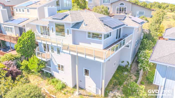 Modern home exterior in Mill Valley featuring Pearl Gray James Hardie siding and Milgard C650 windows with solar panels