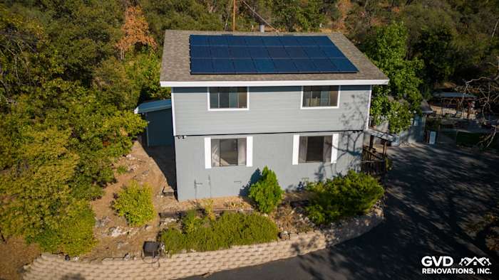 Gray Slate James Hardie Lap Siding with Arctic White trim and solar panels on a transformed home exterior in Colfax, CA