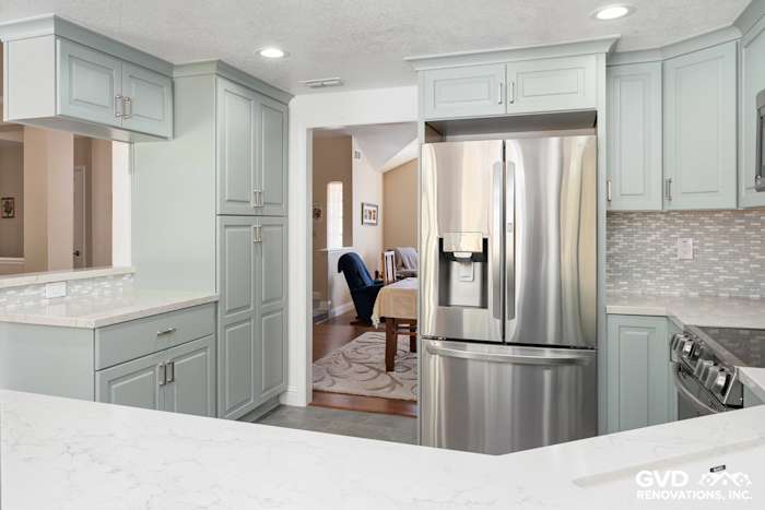 Modern kitchen remodel in Cameron Park featuring light green cabinets, quartz countertops, and stainless steel appliances