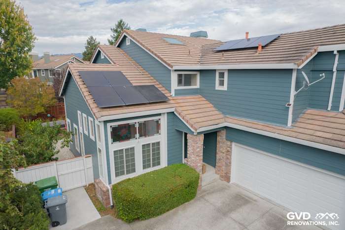 Two-story home exterior featuring James Hardie Evening Blue siding, solar panels, and landscaped front yard in Petaluma, CA
