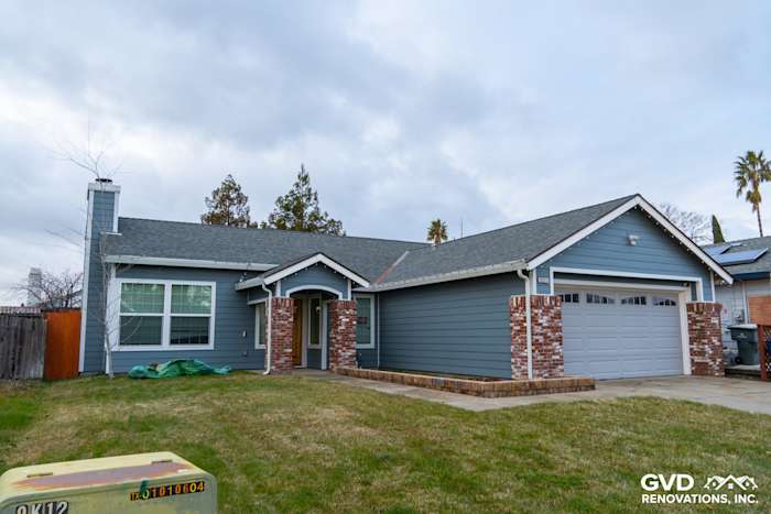 Home exterior featuring Boothbay Blue James Hardie siding, Arctic White trim, and brick accents in Sacramento