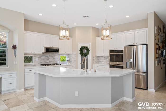 Modern kitchen featuring white cabinetry, quartz countertops, stainless steel appliances, and pendant lighting in Sacramento
