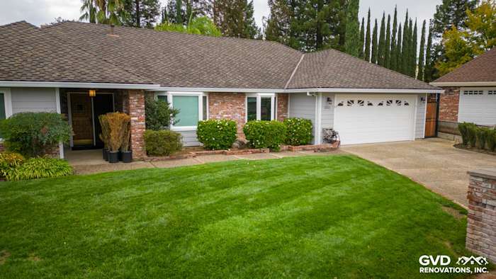 Updated home exterior in Roseville featuring James Hardie Cedarmill siding, Milgard windows, and well-manicured lawn
