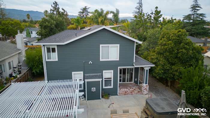Home exterior featuring James Hardie Pearl Gray siding and Arctic White trim in Campbell, CA, with a landscaped backyard