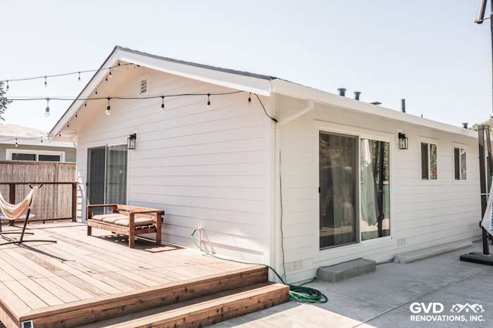 New James Hardie Board and Batten siding on Novato home exterior, featuring a wooden deck and outdoor lighting