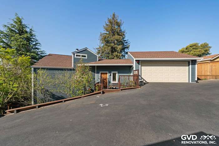 Modern home exterior featuring James Hardie lap siding, a new garage door, and landscaped entry in Oakland, CA