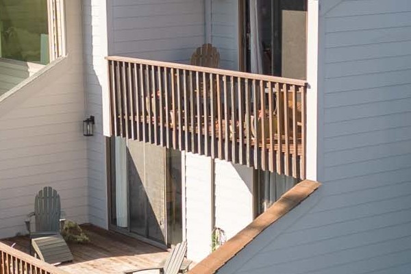 Pearl Gray James Hardie lap siding installed on a unique Mill Valley home with wooden balconies