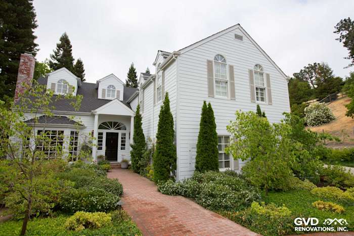 New Arctic White HardiePlank siding and trim on a remodeled home exterior, surrounded by lush landscaping in Orinda, CA