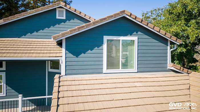 Updated home exterior in Dixon with new gray siding and Anlin windows; decorative tan roof shingles