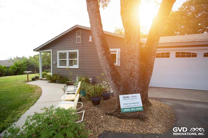 Auburn home with Aged Pewter HardiePlank siding, Arctic White trim, and lush landscaping at sunset