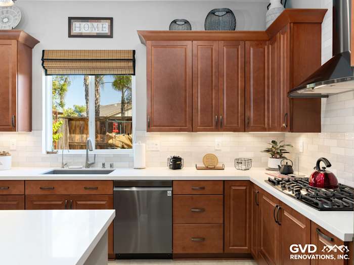 Modern kitchen remodel featuring rich wood cabinets, quartz countertops, and stainless steel appliances in Elk Grove