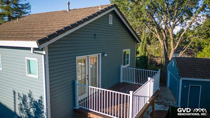 New Alside Prodigy vinyl siding in calming blue-green color with a deck and railings in Folsom, CA