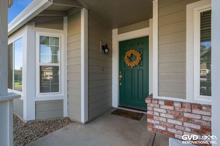 Monterey Taupe HardiePlank Lap Siding and Arctic White trim on a Folsom home's welcoming entrance