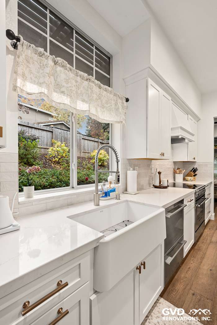 Modern kitchen remodel featuring Waypoint cabinets, Custom Vadara Bronzo countertops, and a farmhouse sink in Folsom, CA
