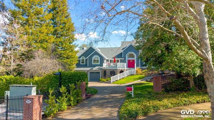 Home exterior featuring Night Gray James Hardie siding and Arctic White trim in Petaluma, CA, with vibrant landscaping