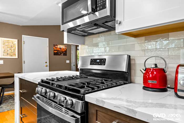 Modern kitchen remodel featuring stainless steel appliances, quartz countertop, and subway tile backsplash in Davis, CA